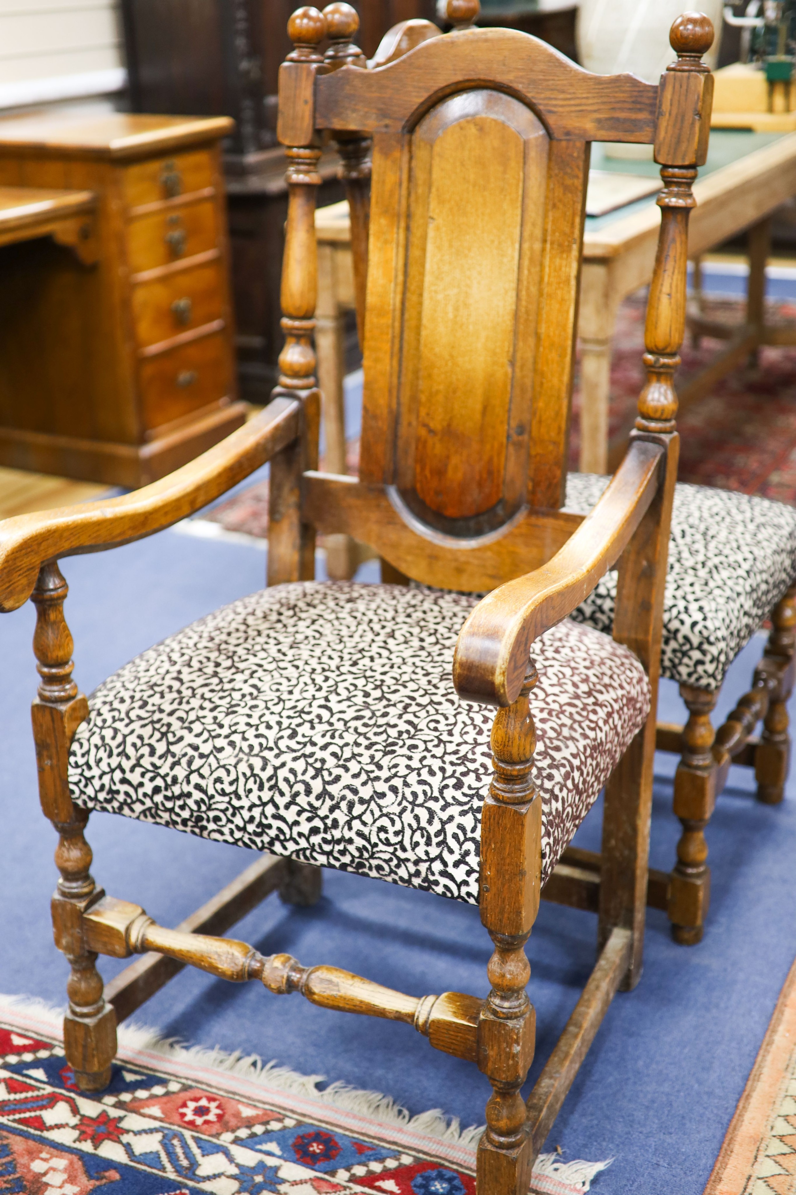 A set of ten 18th century style panelled oak dining chairs, two with arms